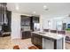 Modern kitchen features granite countertops, stainless appliances, and dark wood cabinetry at 3027 Marine Grass Dr, Wimauma, FL 33598