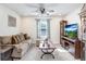 Cozy living room with comfortable couch, ceiling fan and a flat screen TV at 3027 Marine Grass Dr, Wimauma, FL 33598
