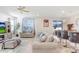 Bright living room with a lake view, comfortable seating, and modern decor at 3027 Marine Grass Dr, Wimauma, FL 33598