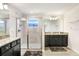 Main bathroom with a walk-in shower, dual vanities and granite countertops at 3027 Marine Grass Dr, Wimauma, FL 33598
