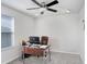 Bright home office with a modern desk, comfortable chair, and neutral carpet at 3027 Marine Grass Dr, Wimauma, FL 33598