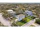 An aerial view of a home with a well-manicured lawn nestled among mature trees in a quiet neighborhood at 3201 S Manhattan Ave, Tampa, FL 33629