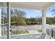 Balcony with white railings and a view of the neighborhood and tree lined street at 3201 S Manhattan Ave, Tampa, FL 33629