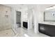 Luxurious Primary bathroom with dual vanities, glass shower, and tile flooring at 3201 S Manhattan Ave, Tampa, FL 33629