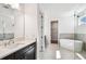 A modern bathroom features a vanity with black cabinets and a soaking tub at 3201 S Manhattan Ave, Tampa, FL 33629
