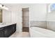 Elegant bathroom featuring a soaking tub, double vanity, and walk in closet at 3201 S Manhattan Ave, Tampa, FL 33629