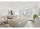 Bright bedroom featuring a tray ceiling, light gray walls, and natural light from the window at 3201 S Manhattan Ave, Tampa, FL 33629