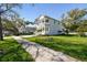 Inviting two-story home with a well-manicured lawn and a welcoming front porch at 3201 S Manhattan Ave, Tampa, FL 33629