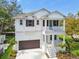 Charming two-story home with a two-car garage, a balcony, and a well-manicured lawn with new landscaping at 3201 S Manhattan Ave, Tampa, FL 33629
