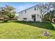 Exterior of a white two-story home featuring pristine landscaping, a manicured lawn, and an inviting outdoor space at 3201 S Manhattan Ave, Tampa, FL 33629