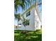 Two-story white home featuring a modern design, lush lawn and beautiful landscaping at 3201 S Manhattan Ave, Tampa, FL 33629