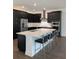 Contemporary kitchen featuring dark cabinets, stainless steel appliances, and a center island with white countertop at 3201 S Manhattan Ave, Tampa, FL 33629