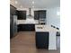 Elegant kitchen with dark cabinetry, stainless steel appliances, and spacious island perfect for dining at 3201 S Manhattan Ave, Tampa, FL 33629