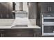 Modern kitchen with stainless appliances, dark cabinets and a white countertop at 3201 S Manhattan Ave, Tampa, FL 33629