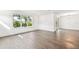Bright, open living room with hardwood floors, large windows, and sliding glass doors at 3201 S Manhattan Ave, Tampa, FL 33629
