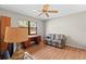 Bedroom with a ceiling fan, wood floors, and a large window at 3285 Sandy Ridge Dr, Clearwater, FL 33761