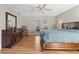 A main bedroom with wood floors, a ceiling fan, and French doors leading outside to the patio at 3285 Sandy Ridge Dr, Clearwater, FL 33761