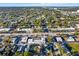 Aerial view of a neighborhood with tree-lined streets, various businesses, and clear blue skies at 3711 1St S Ave, St Petersburg, FL 33711