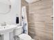 Clean bathroom featuring tiled walls, walk in shower, and a modern sink at 3711 1St S Ave, St Petersburg, FL 33711