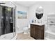 Modern bathroom with a shower, vanity, and wood-look tile flooring, offering a clean and stylish design at 3711 1St S Ave, St Petersburg, FL 33711