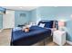 Inviting bedroom with a comfortable bed, stylish nightstands, couch and calming blue walls at 3711 1St S Ave, St Petersburg, FL 33711
