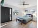 Bright bedroom featuring a queen bed, ceiling fan, and a mirrored closet door, maximizing space and light at 3711 1St S Ave, St Petersburg, FL 33711
