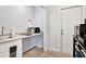 Efficient kitchenette with modern appliances, granite countertop, and wooden floors, plus a door to the outside at 3711 1St S Ave, St Petersburg, FL 33711