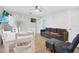 Open-concept living area with a sofa, dining table, and modern decor, perfect for comfortable living and entertaining at 3711 1St S Ave, St Petersburg, FL 33711