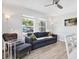 Bright living room with hardwood floors, modern furniture, and large windows providing natural light at 3711 1St S Ave, St Petersburg, FL 33711