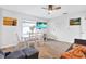 Bright living area with a dining table, sofa, and wall-mounted TV, offering a versatile and inviting space at 3711 1St S Ave, St Petersburg, FL 33711