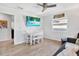 Open-concept living space with tile floors, a dining table, and a wall-mounted television at 3711 1St S Ave, St Petersburg, FL 33711