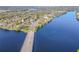 Aerial view showcasing the home's proximity to the river, the nearby bridge, and surrounding trees at 3820 E Lakeshore Dr, Tampa, FL 33604