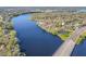 Aerial view showcasing the home's proximity to the river, the nearby bridge, and surrounding trees at 3820 E Lakeshore Dr, Tampa, FL 33604