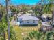 Aerial view of the backyard with a shed, stepping stones, and fenced perimeter at 3820 E Lakeshore Dr, Tampa, FL 33604