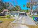 Charming single-story home with well-maintained landscaping and a spacious driveway at 3820 E Lakeshore Dr, Tampa, FL 33604