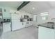 Bright kitchen features white cabinetry, stainless steel appliances, and neutral tile flooring at 3820 E Lakeshore Dr, Tampa, FL 33604