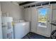 A laundry room features a washer and dryer and access to the yard at 3820 E Lakeshore Dr, Tampa, FL 33604