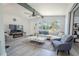 Cozy living room featuring stylish furniture, a large window, and a fireplace, with a relaxing ambiance at 3820 E Lakeshore Dr, Tampa, FL 33604