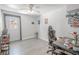 A home office features gray wood-look floors, a fan, and ample lighting at 3820 E Lakeshore Dr, Tampa, FL 33604