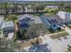 Home aerial view showcasing the landscape, nearby street, and neighboring residences on a sunny day at 410 Manns Harbor Dr, Apollo Beach, FL 33572