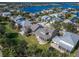 A high-angle shot of houses with backyard patios nestled in a community near a sparkling waterfront and lush greenery at 410 Manns Harbor Dr, Apollo Beach, FL 33572