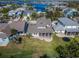 Overhead view of a neighborhood showcasing homes with screened patios, green lawns, and community with beautiful waterways at 410 Manns Harbor Dr, Apollo Beach, FL 33572