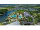 Aerial view of the community, showcasing a lakefront setting, swimming pool, clubhouse, and residential homes at 410 Manns Harbor Dr, Apollo Beach, FL 33572