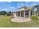 View of the backyard featuring the screened in patio and a brick fire pit at 410 Manns Harbor Dr, Apollo Beach, FL 33572