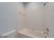 Clean white bathroom with a combined shower and tub at 410 Manns Harbor Dr, Apollo Beach, FL 33572