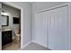 Attached bath area with coordinating vanity, wall cabinet, and tile flooring at 410 Manns Harbor Dr, Apollo Beach, FL 33572