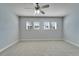 Spacious bedroom with plush carpeting, a ceiling fan, and multiple windows at 410 Manns Harbor Dr, Apollo Beach, FL 33572