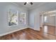 Bright bedroom featuring hardwood floors, two windows, and neutral paint at 410 Manns Harbor Dr, Apollo Beach, FL 33572