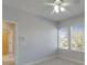 Bedroom features two bright windows, neutral carpet, and an open door to bath at 410 Manns Harbor Dr, Apollo Beach, FL 33572