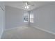 Empty bedroom featuring neutral walls, carpeted floors, and large windows at 410 Manns Harbor Dr, Apollo Beach, FL 33572